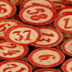A collection of red and white numbered bingo chips scattered and overlapping.