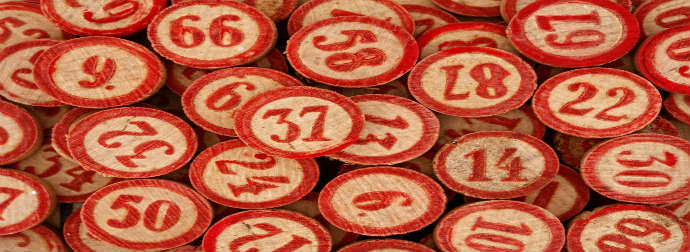 A collection of red and white numbered bingo chips scattered and overlapping.