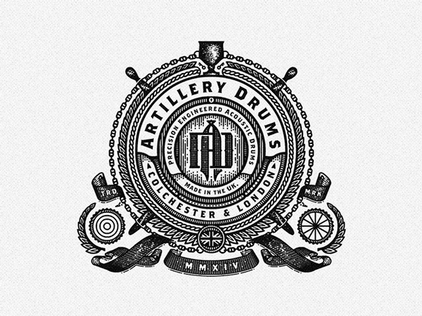 Vintage-style emblem for Artillery Drums featuring the text 'Precision Engineered Acoustics' and 'Made in the UK, Rochester & London' with decorative cannons, cannonballs, a shield with 'AD', crossed drumsticks, a crown, and the year 'MMXIV' in Roman numerals.