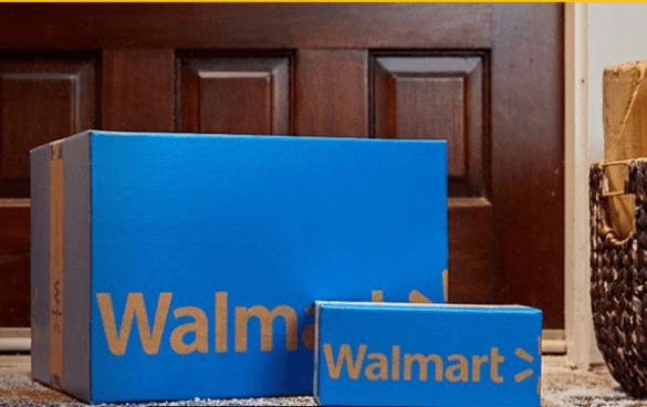 Two blue Walmart delivery boxes of different sizes with the Walmart logo on them, placed in front of a house door, with a woven basket to the side.