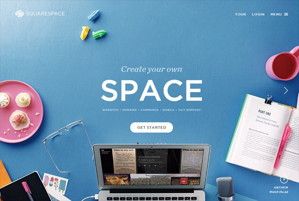 Squarespace homepage with a promotional message 'Create your own SPACE' above a desk with a laptop, glasses, notebook, coffee, cupcakes, and office supplies, and a 'GET STARTED' button.