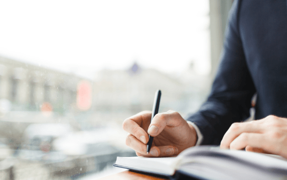 Man writing in a book