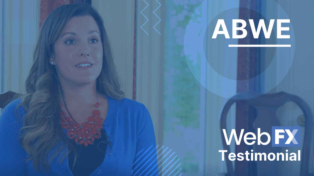 Woman in blue cardigan and red necklace speaking in a testimonial video with ABWE and Web FX logos.