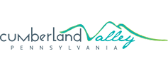 Logo of Cumberland Valley Pennsylvania featuring stylized mountain peaks and waves in green and blue colors above the text.