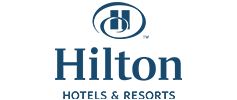 Logo of Hilton Hotels & Resorts, featuring the letter 'H' inside a circle next to the word 'Hilton' with 'Hotels & Resorts' written underneath.