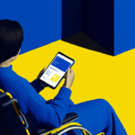 Person in a wheelchair holding a tablet.