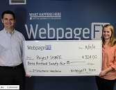 Two individuals, a man and a woman, holding a large ceremonial check from WebpageFX to Project SHARE for $384.00, standing in front of a wall with the WebpageFX logo.