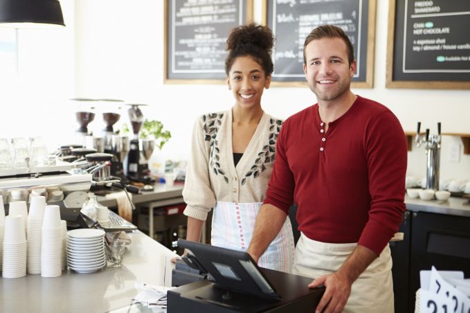 Male and female business owners smiling