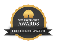 Web Excellence Awards badge featuring an Excellence Award with a gold seal in the center, surrounded by a black circular band with the text 'Web Excellence Awards' at the top and 'Excellence Award' at the bottom, all framed by a black ribbon with gold edges.