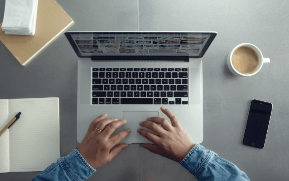 Man typing on a laptop at work