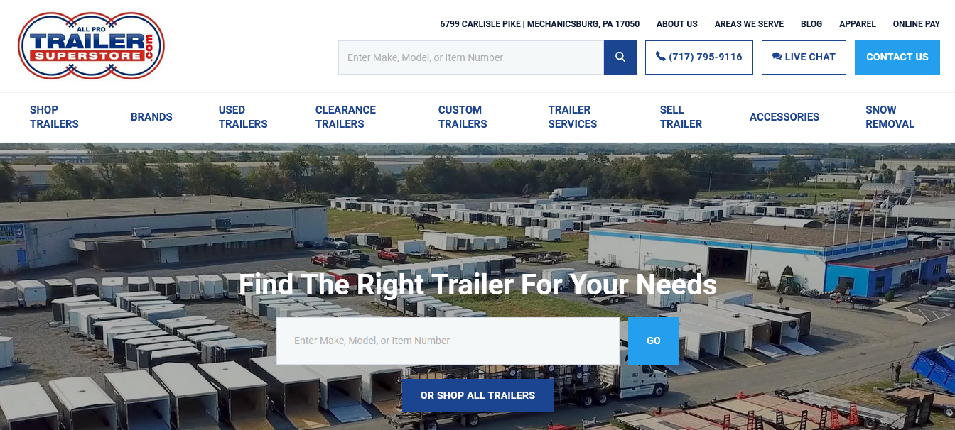 Aerial view of All Pro Trailer Superstore with rows of trailers for sale, a large building with signage, and website navigation options.
