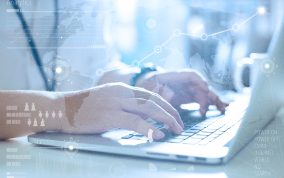 Close-up of hands typing on a laptop keyboard with a digital analytics overlay including icons and a graph line.