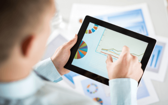 Man analyzing data charts on a tablet