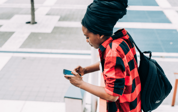 Woman browsing on her phone in a center city area