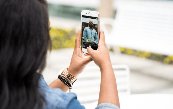 Woman shooting a video of a man on her iPhone