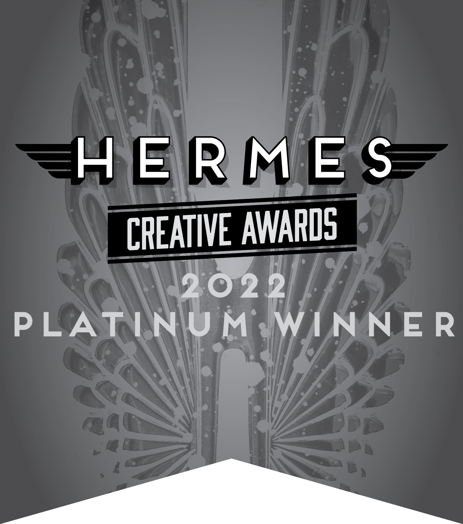 Graphic for Hermes Creative Awards 2022 displaying 'PLATINUM WINNER' with an abstract symmetrical design in grayscale.