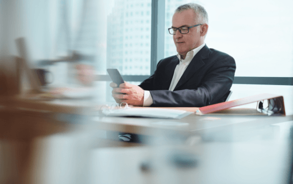 Business man checking emails on his smartphone