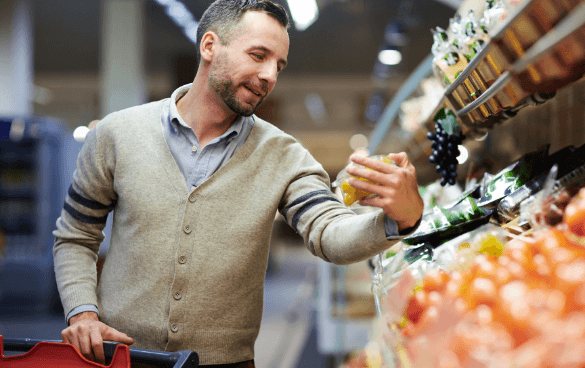 Man shopping the produce aisle at a grocery store