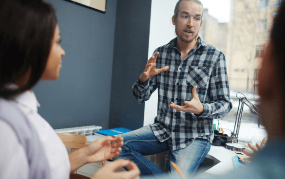 Man sharing ideas with coworkers