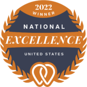 Logo of a 2022 National Winner for Excellence in the United States, featuring an orange laurel wreath design with a heart and location pin in the center.