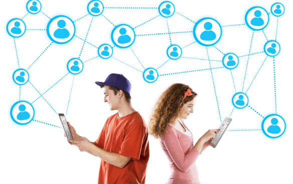 A young man and woman standing back to back, each smiling at their tablets, with a graphic of a social network connecting people icons in the background, symbolizing online connectivity.