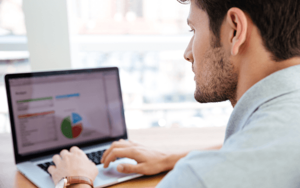 Man analyzing graphs of data on a computer