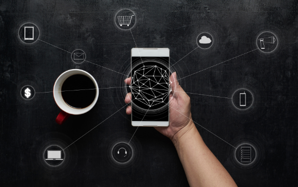 A hand holding a smartphone with a geometric pattern on the screen, surrounded by icons representing digital services and a red coffee mug, symbolizing network connectivity.