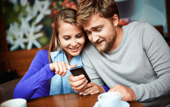 Two people looking at a phone