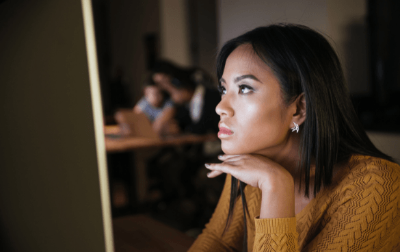 Woman staring at a computer screen