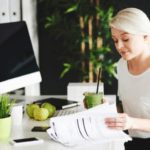 Woman reviewing papers at a desk in an office