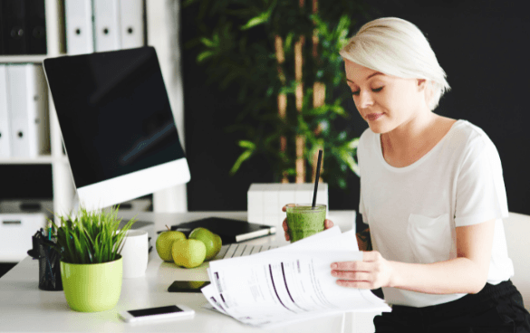 Woman reviewing papers at a desk in an office