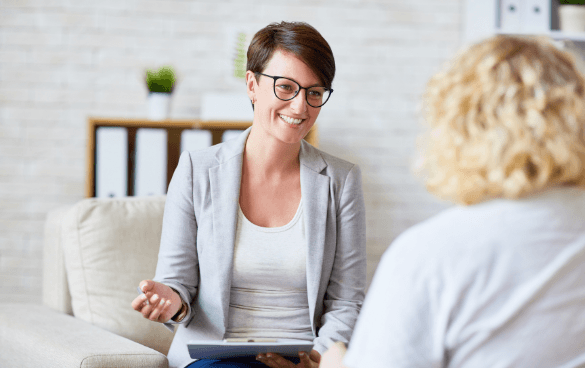 Woman sitting with therapist in a therapist office