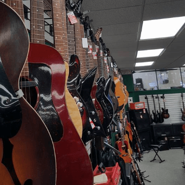 guitars hanging from wall