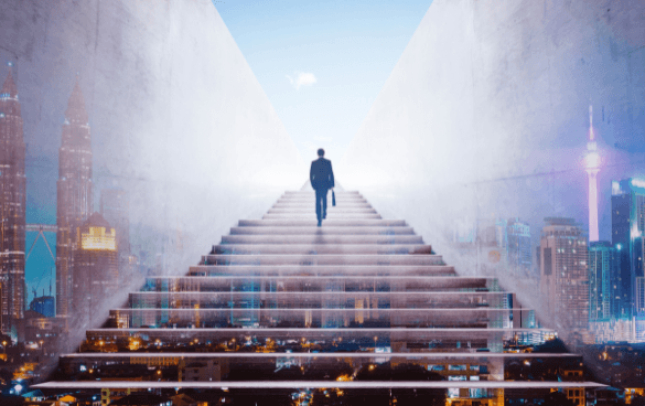 Man walking up giant stairs through city