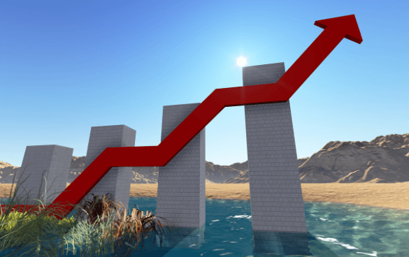 A 3D bar graph with rising columns made of grey blocks in a desert landscape, with a red upward-pointing arrow indicating growth, set against a clear blue sky.