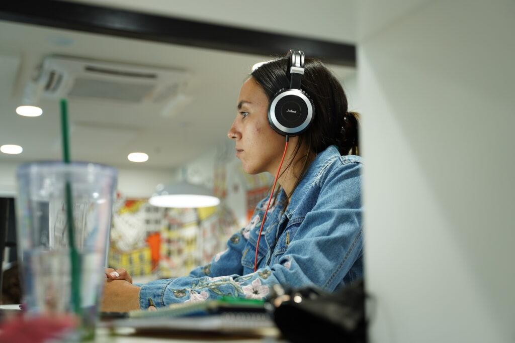 WebFX employee with headphones working at desk