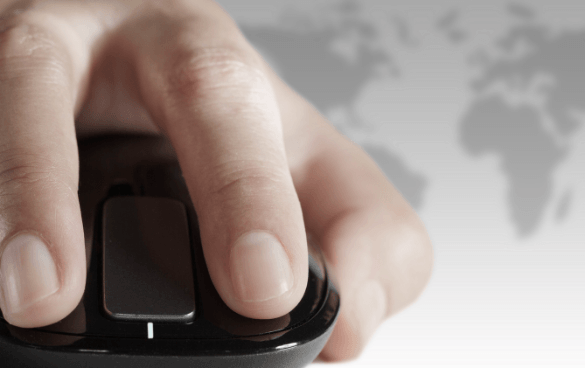 Close-up of a hand on a computer mouse with a faint world map in the background.