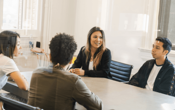 Office workers sitting at a table having a discussion