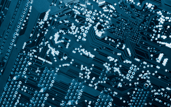 Close-up of a blue circuit board with intricate metallic solder points and traces.