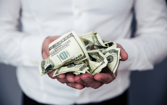 Many in a button-up shirt holding a pile of crinkled dollar bills