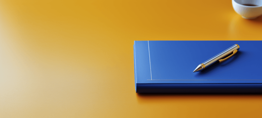 Blue padfolio laaying on a yellow desk with a pen on the padfolio