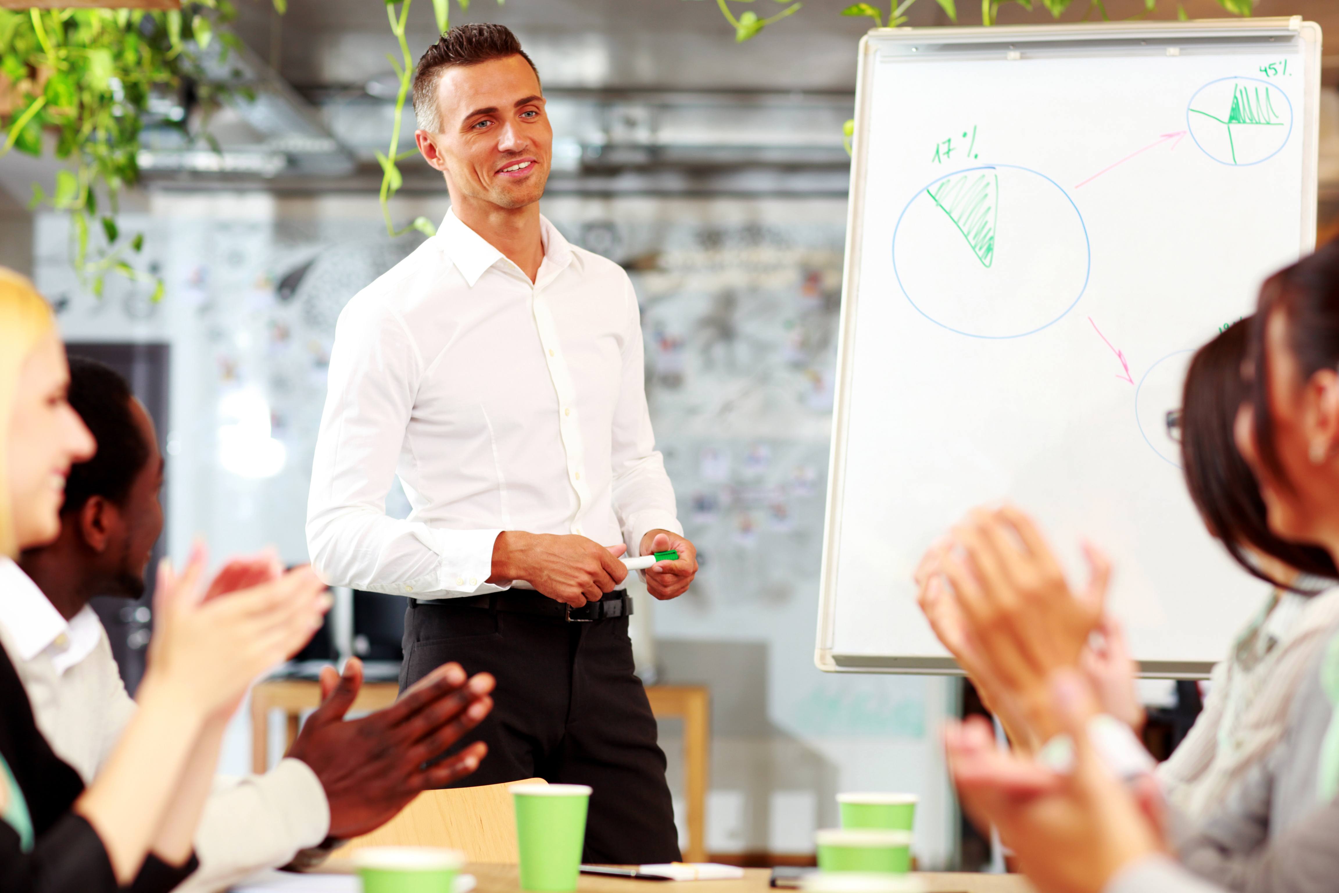 Cheerful business people applauding in a meeting. Business concept.