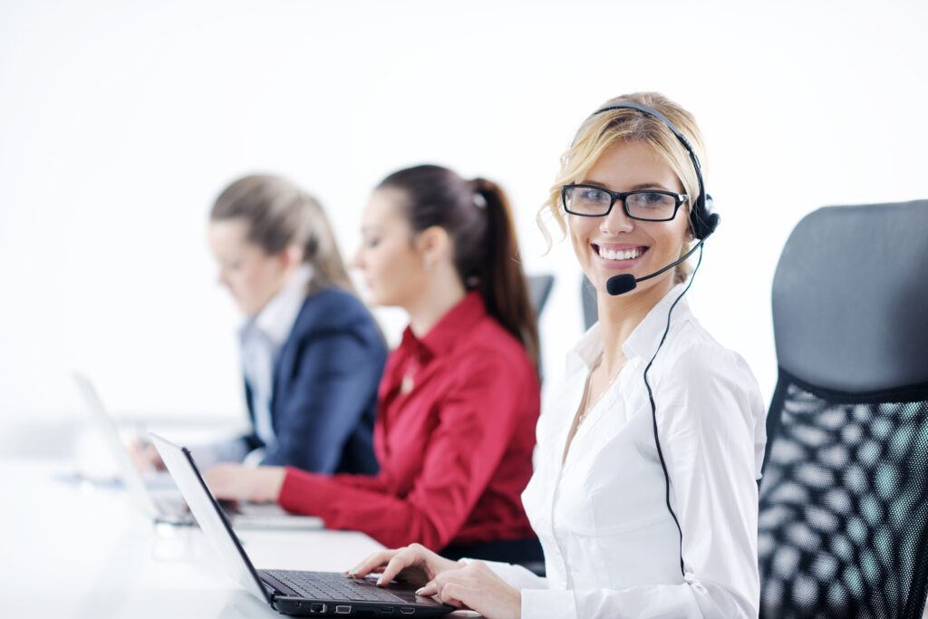 young business woman group with headphones smiling at you against white background