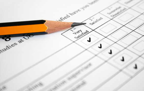 A close-up of a survey form with multiple choice answers, where 'Very Satisfied' is selected with a check mark. A pencil with a broken tip is resting on the form.