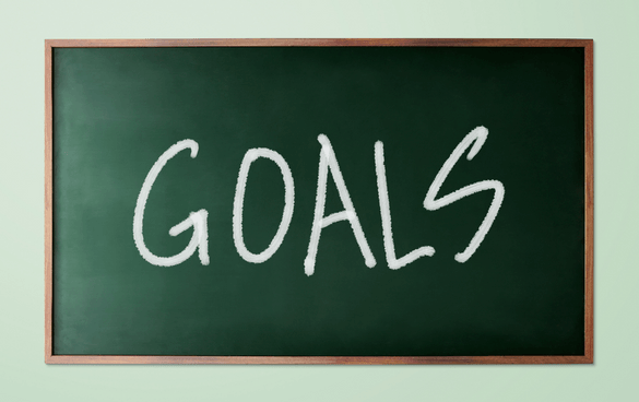 The word 'GOALS' written in white chalk on a green chalkboard.