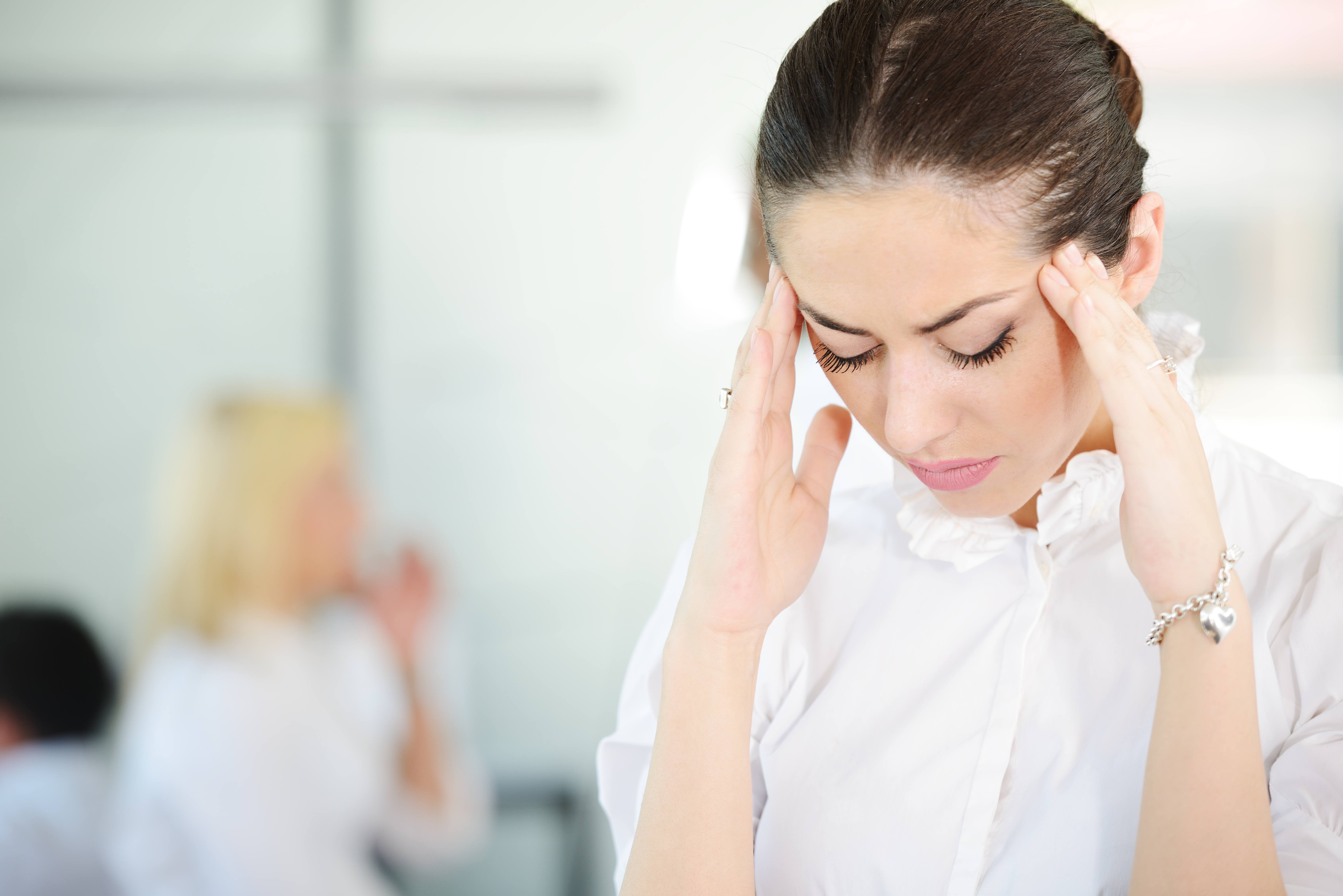 Business person with stress and worries in office