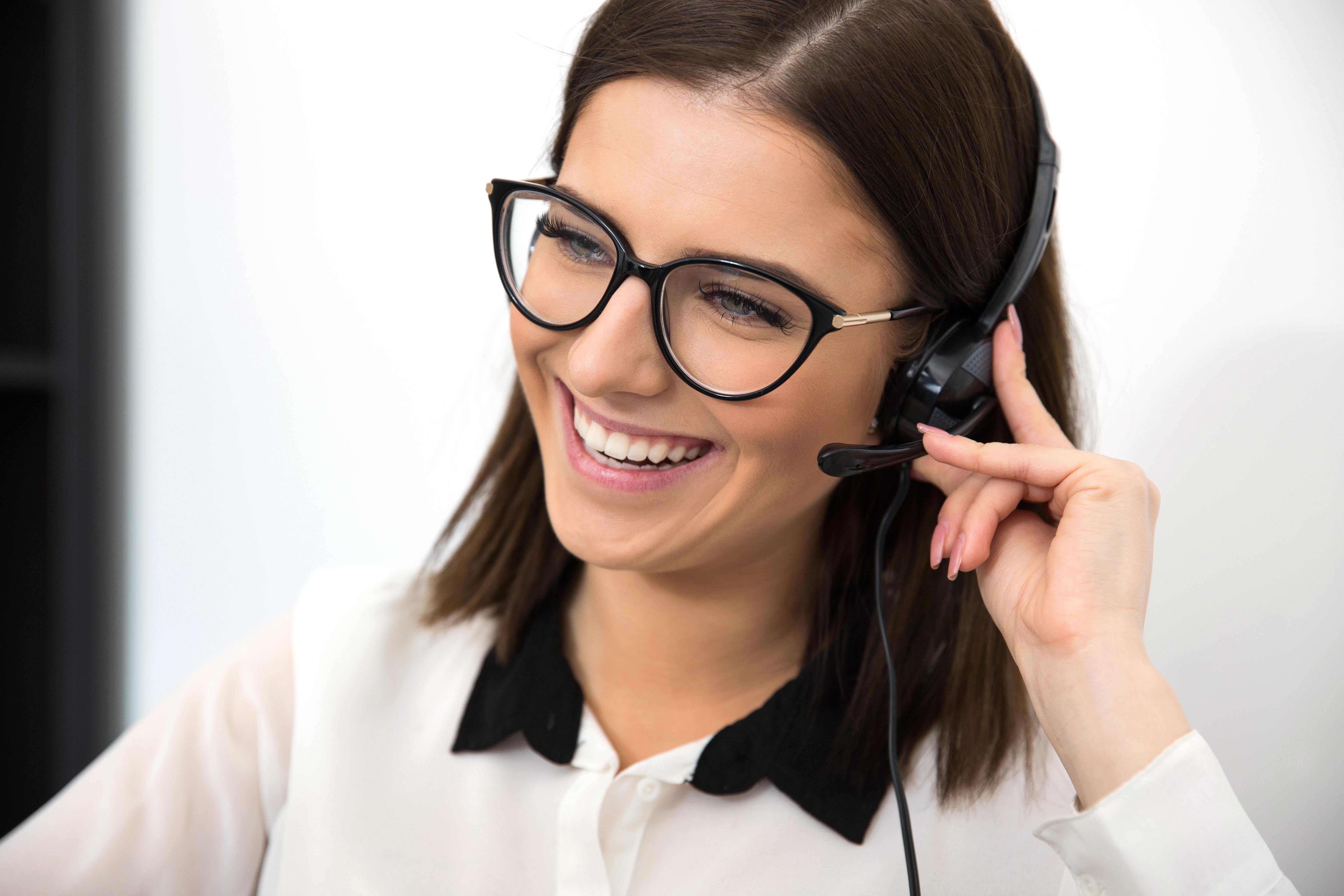 cheerful female support operator in headset SBI 300854753 scaled