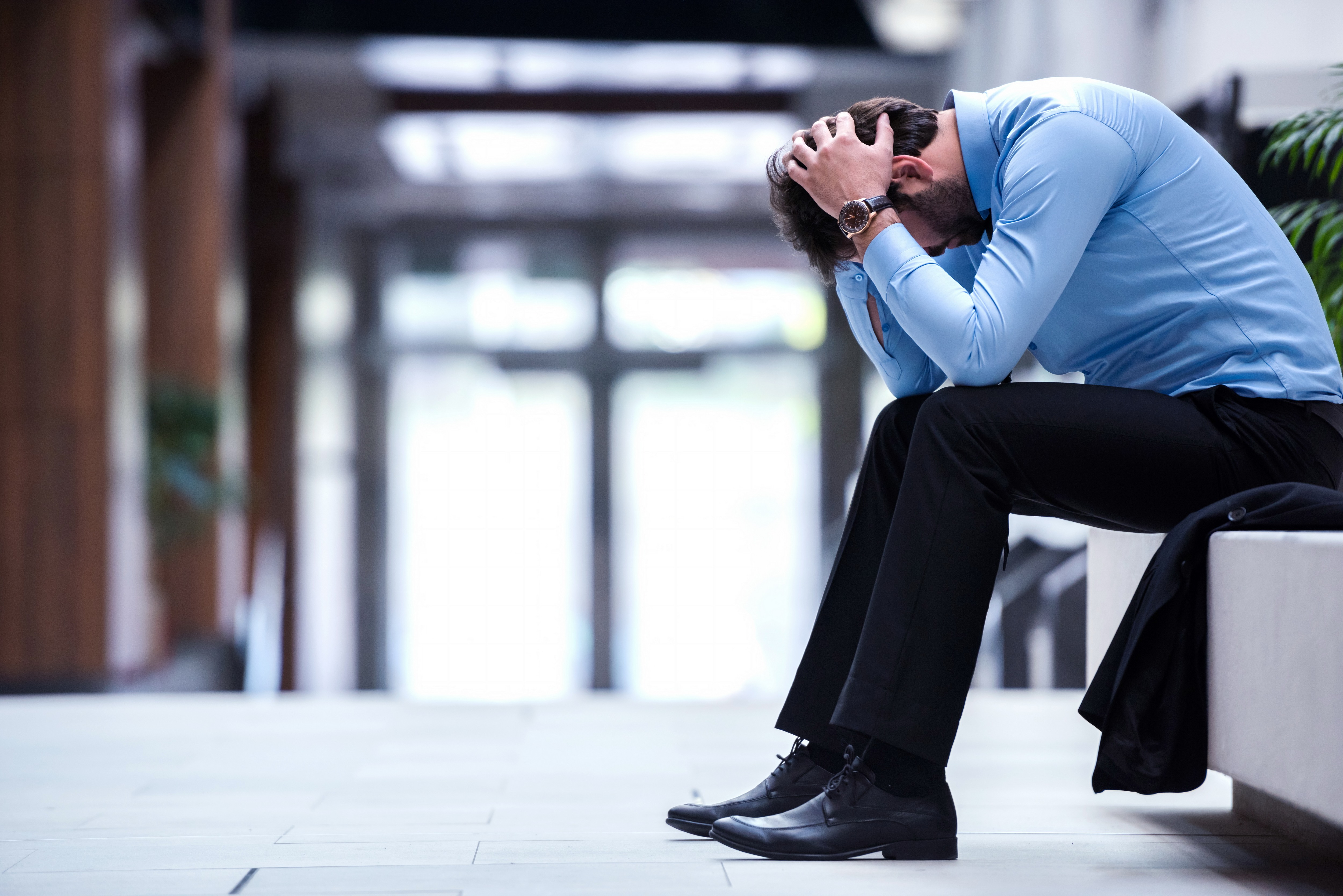 frustrated young business man working on laptop computer at office