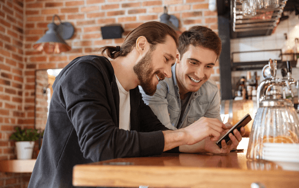 two guys watching videos on their phones