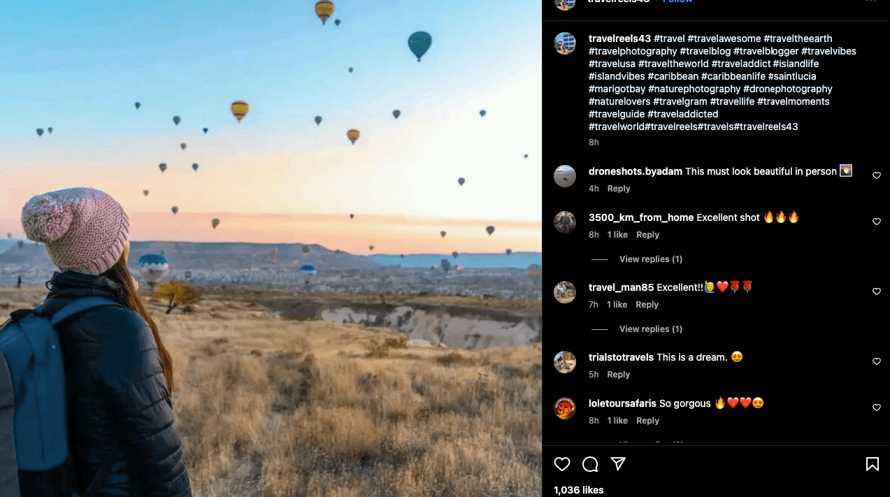 Instagram post from a traveler standing in a field with hot air balloons floating in the distance